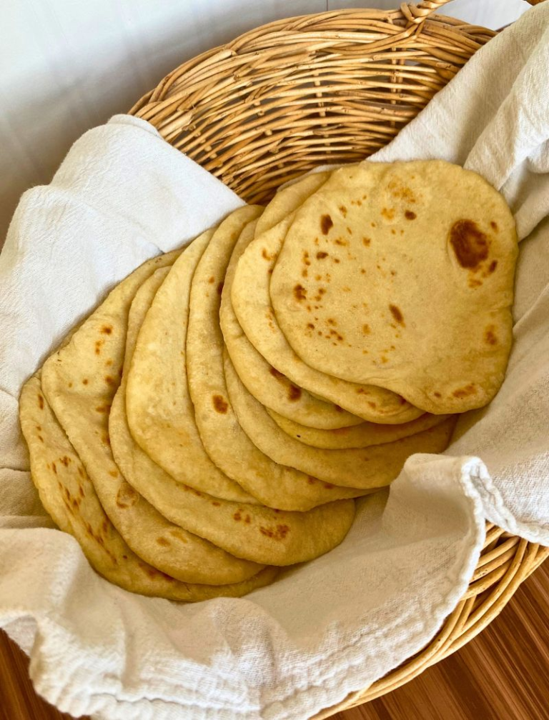 Sourdough tortillas in a basket with a white towel