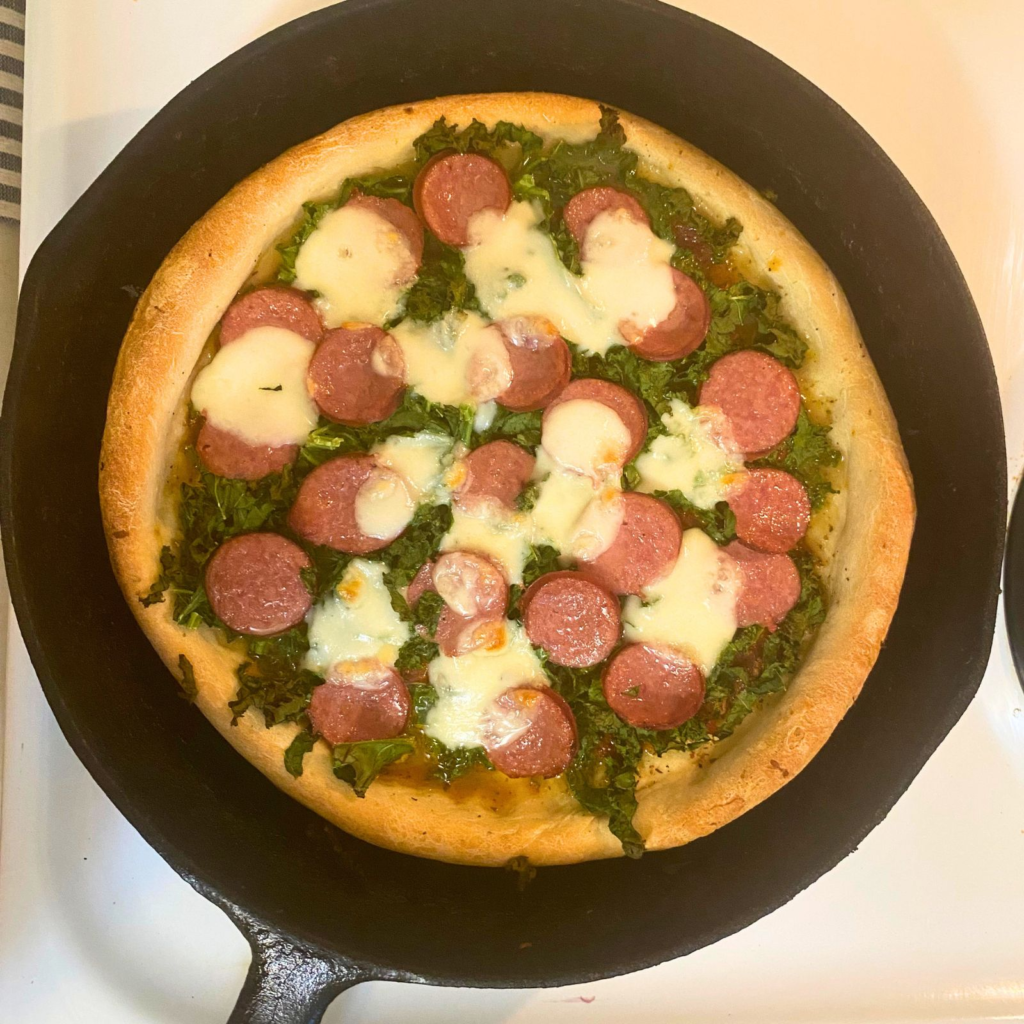 Homemade sourdough pizza in a cast-iron skillet