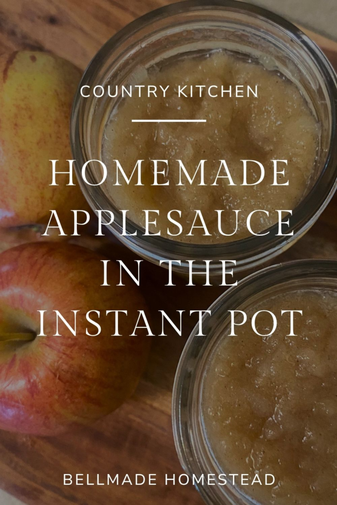 Applesauce in mason jars next to red apples