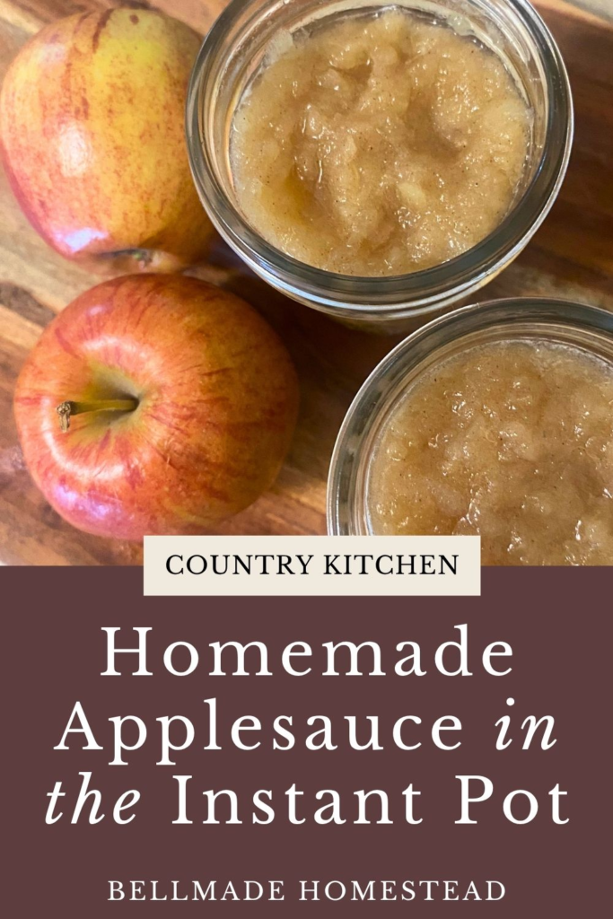 Applesauce in mason jars next to red apples